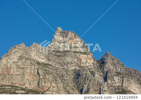 Scenic landscape of Table Mountain in Cape Town, South Africa against a clear blue sky background from below with copy space. Beautiful panoramic of an iconic landmark and famous travel destination Scenic landscape of Table Mountain in Cape Town, South Africa against a clear blue sky background from below with copy space. Beautiful panoramic of an iconic landmark and famous travel destination 121819804