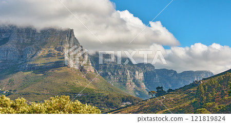 Landscape banner view of a mountain with clouds rolling over in a blue sky in summer. Copyspace, scenic and panoramic view of a natural environment in the countryside. Scenery of hills and nature 121819824
