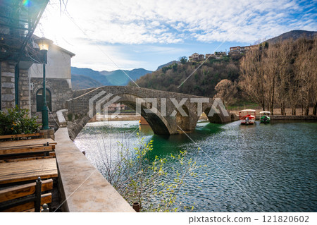 Arched bridge over Crnojevic river in small town near Skadar lake in Montenegro in winter time 121820602