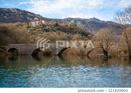 Arched bridge over Crnojevic river in small town near Skadar lake in Montenegro in winter time Arched bridge over Crnojevic river in small town near Skadar lake in Montenegro in winter time 121820603