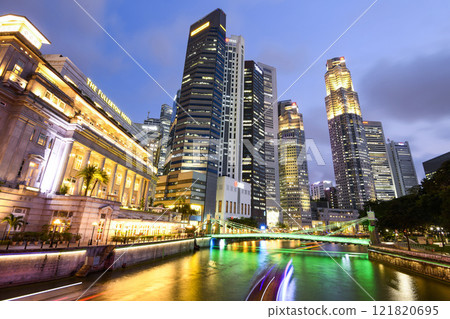 Building view of the Fullerton Hotel, Cavenagh Bridge, and financial district skyscrapers along the Singapore River. Building view of the Fullerton Hotel, Cavenagh Bridge, and financial district skyscrapers along the Singapore River. 121820695