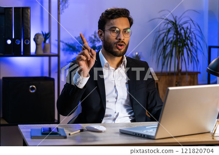 Business man working on laptop shakes finger, saying no, be careful, giving advice to avoid mistake 121820704