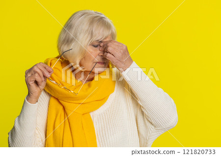Exhausted tired senior woman takes off glasses, rubbing eyes feels pain, sleepy exhausted, overwork 121820733