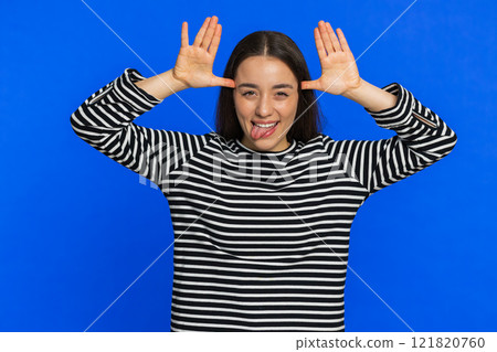 Funny bully Caucasian young woman showing tongue making silly faces, fooling around, joking, teasing Funny bully Caucasian young woman showing tongue making silly faces, fooling around, joking, teasing 121820760