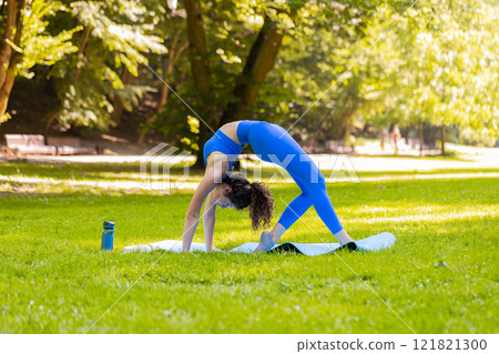 Flexible young woman doing yoga stretching exercises on mat, workout, gymnastic domestic fitness Flexible young woman doing yoga stretching exercises on mat, workout, gymnastic domestic fitness 121821300