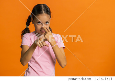 School child girl show pointing at her eyes and camera I am watching you gesture, spying on someone 121821341