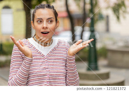 Amazed woman open mouth looking surprised through street with big open eyes shocked by something 121821372
