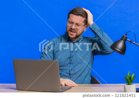 Man using laptop surprised by bad news, fortune loss, game fail, lottery results sitting at table Man using laptop surprised by bad news, fortune loss, game fail, lottery results sitting at table 121821451