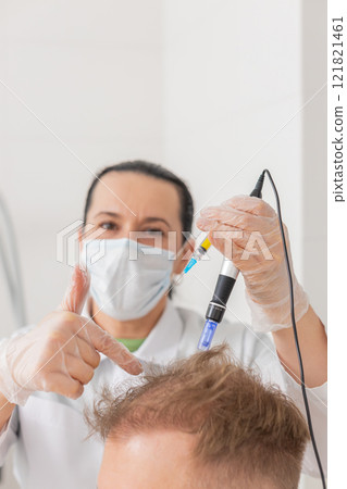 Trichologist doing man improve hair growth procedure, dermapen microneedling, vitamin injections Trichologist doing man improve hair growth procedure, dermapen microneedling, vitamin injections 121821461
