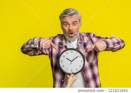 Mature man holding big office clock, urgent deadline sign, anxious lateness gesture time pressure Mature man holding big office clock, urgent deadline sign, anxious lateness gesture time pressure 121821642