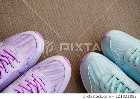 The toes of brand new sneakers for elementary school girls. They come in two different colors: lavender and light blue. 121821882