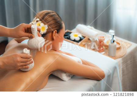 Hot herbal ball spa massage body treatment at day spa . Quiescent 121821898