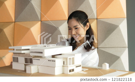 Skilled architect holds architect model while check mistake point. Manipulator. Skilled architect holds architect model while check mistake point. Manipulator. 121822118