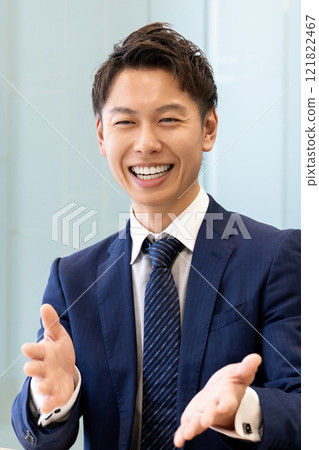 Smiling Japanese male businessman having a conversation Smiling Japanese male businessman having a conversation 121822467