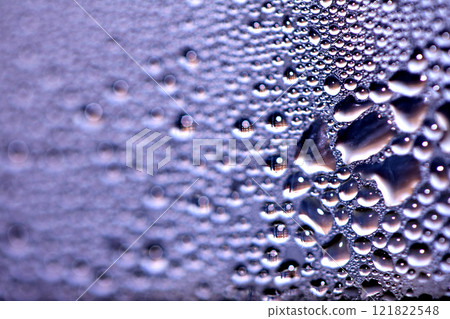 Close Up of Condensation Floating Liquid Water Bubbles and Drips on Glass from Rain Close Up of Condensation Floating Liquid Water Bubbles and Drips on Glass from Rain 121822548