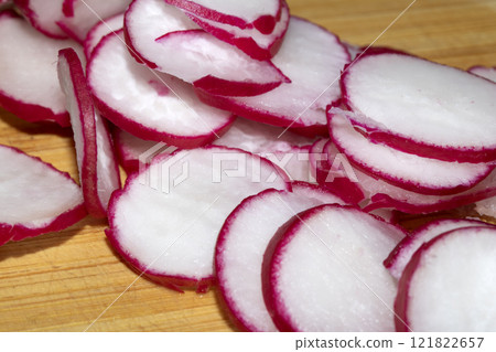 Chopped Up Sliced Radish on a Chopping Board in a Kitchen Chopped Up Sliced Radish on a Chopping Board in a Kitchen 121822657