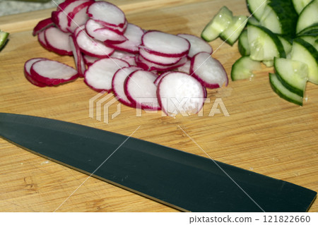 Chopped Up Sliced Radish on a Chopping Board in a Kitchen Chopped Up Sliced Radish on a Chopping Board in a Kitchen 121822660