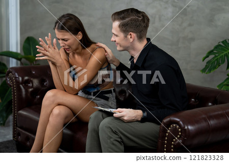 Psychiatrist comforting and supporting stressed and depressed patient. Unveiling Psychiatrist comforting and supporting stressed and depressed patient. Unveiling 121823328
