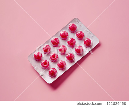 raspberry berries in a pill blister, concept of natural vitamins 121824468