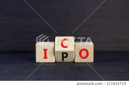 Initial public or coin offering symbol. Concept words abbreviation IPO or ICO on wooden block. Beautiful black table black background. Business Initial public or coin offering concept. Copy space. 121824729