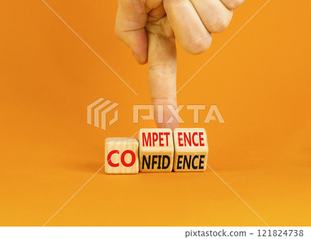 Competence and confidence symbol. Concept word Competence Confidence on wooden cubes. Businessman hand. Beautiful orange table orange background. Business competence confidence concept. Copy space. Competence and confidence symbol. Concept word Competence Confidence on wooden cubes. Businessman hand. Beautiful orange table orange background. Business competence confidence concept. Copy space. 121824738