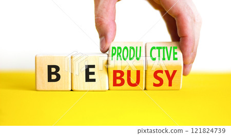 Be productive not busy symbol. Concept words Be productive Be busy on wooden block. Beautiful yellow table white background. Businessman hand. Business be productive not busy concept. Copy space. Be productive not busy symbol. Concept words Be productive Be busy on wooden block. Beautiful yellow table white background. Businessman hand. Business be productive not busy concept. Copy space. 121824739