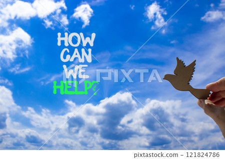 How can we help symbol. Concept words How can we help. Beautiful blue sky and clouds background. Businessman hand with wooden bird. Business and how can we help concept. Copy space. How can we help symbol. Concept words How can we help. Beautiful blue sky and clouds background. Businessman hand with wooden bird. Business and how can we help concept. Copy space. 121824786
