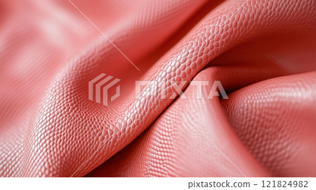 Close-up of textured pink leather fabric with intricate detailing and folded patterns 121824982