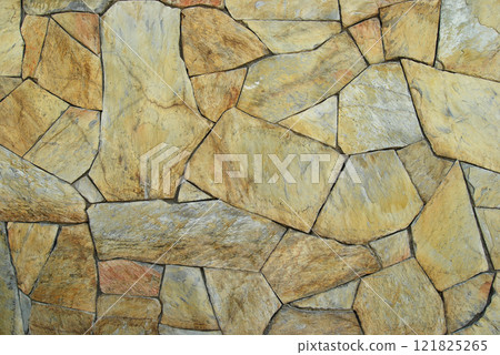 Sturdy yellow and beige cut stone wall, seamless lined up Sturdy yellow and beige cut stone wall, seamless lined up 121825265