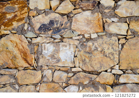 Sturdy yellow and beige cut stone wall, seamless lined up 121825272