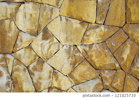Sturdy yellow and beige cut stone wall, seamless lined up 121825710