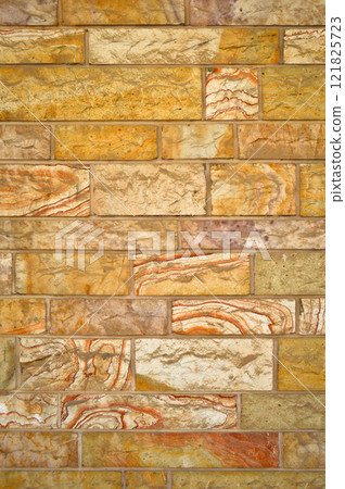 Sturdy yellow and beige cut stone wall, seamless lined up Sturdy yellow and beige cut stone wall, seamless lined up 121825723