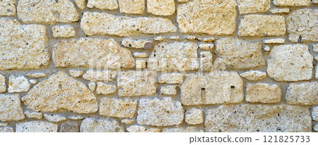 Sturdy yellow and beige cut stone wall, seamless lined up 121825733