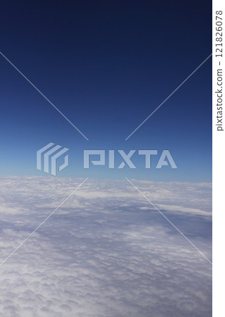 Sea of clouds and blue sky over Brazil seen from an airplane window 121826078