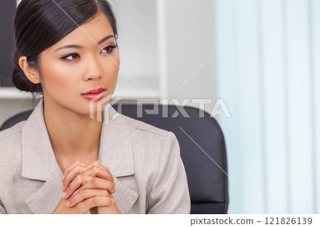 Asian Chinese Woman or Businesswoman in her Office 121826139