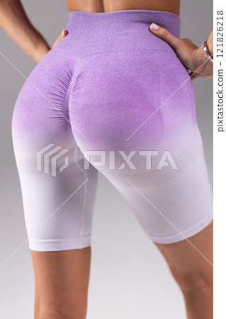 Purple gradient leggings close-up, showcasing textured fabric and fit, highlighting fashion and style, activewear concept 121826218
