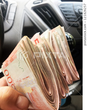 a stack of 500 Swedish kronor banknotes are passed around inside the car 121826257