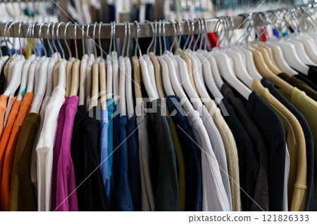 Colorful collection of shirts hanging in a vibrant clothing store display Colorful collection of shirts hanging in a vibrant clothing store display 121826333