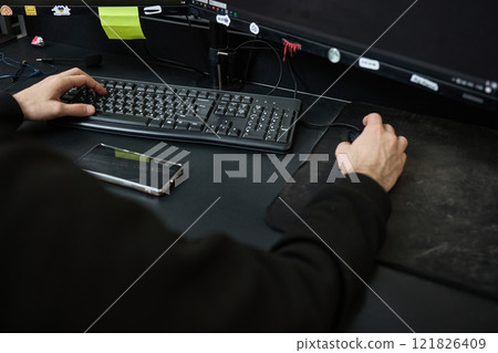 Person working on computer with keyboard and mouse at office desk with smartphone beside organized workspace concept Person working on computer with keyboard and mouse at office desk with smartphone beside organized workspace concept 121826409
