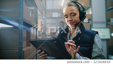 Female Customer Support Specialist in Logistics in Headset Talks on Call with Client, Uses Tablet 121826610