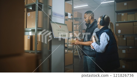 Female Logistics Manager Uses Tablet Computer, African American Employee Scans Parcel at Postal Terminal Female Logistics Manager Uses Tablet Computer, African American Employee Scans Parcel at Postal Terminal 121826736