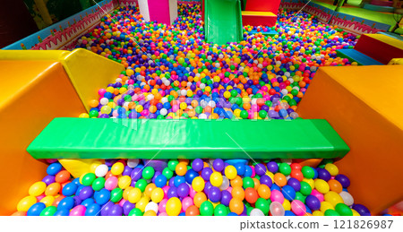 A vibrant ball pit filled with colorful balls and soft play elements for kids fun. A vibrant ball pit filled with colorful balls and soft play elements for kids fun. 121826987