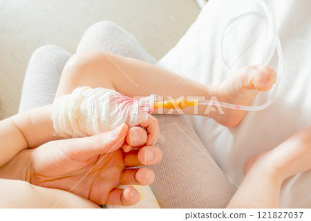 baby in hospital with intravenous saline. Sick children, are lying and being treated in beds in hospitals. baby in hospital with intravenous saline. Sick children, are lying and being treated in beds in hospitals. 121827037