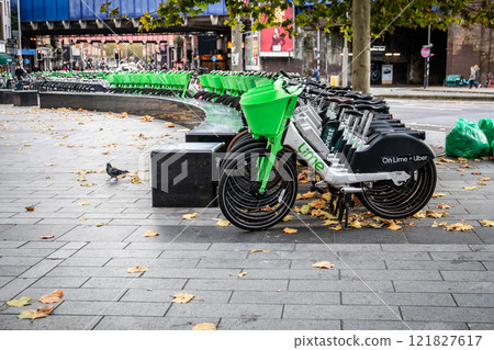 Lime and Forest electric bikes in streets of London placed for rent. Lime and Forest electric bikes in streets of London placed for rent. 121827617