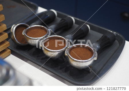 Four Coffee Portafilters Are Prepared and Ready for Brewing a Perfect Cup Four Coffee Portafilters Are Prepared and Ready for Brewing a Perfect Cup 121827770