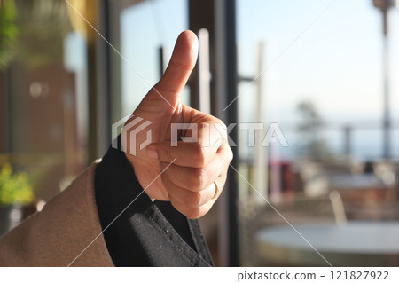 Hand Gesture A Thumbs Up Sign in a Welcoming Indoor Setting Here Hand Gesture A Thumbs Up Sign in a Welcoming Indoor Setting Here 121827922