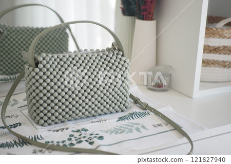 A Beautiful and Stylish Green Handbag Featuring a Unique Beaded Design 121827940