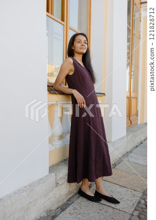 young African American woman in brown dress poses in park. happy female model at sunset in summer young African American woman in brown dress poses in park. happy female model at sunset in summer 121828712