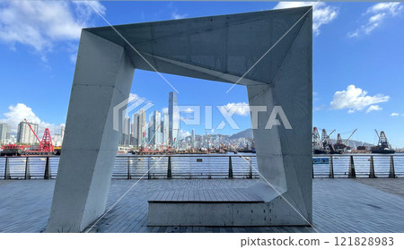 Hong Kong Victoria Harbour with cityscape, ships, textured floor and fixture in outdoor park 121828983