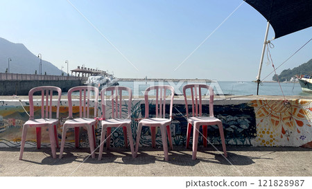 Hong Kong outdoor recreational place, pink chairs, ships, pier in water harbour Hong Kong outdoor recreational place, pink chairs, ships, pier in water harbour 121828987